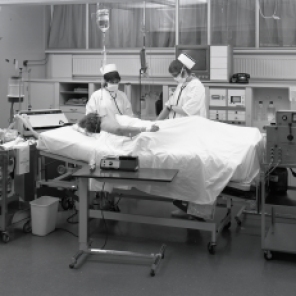2016_107_025a Two nurses at a patient's bedside and typical monitoring equipment, 1970