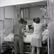 2016_107_055 ICU staff attending to a patient, 1976