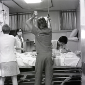 2016_107_060 ICU staff attending to a patient, 1976
