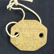 Ruby Dickie's Queen Alexandra's Imperial Military Nursing Service Reserve beige identification tag.